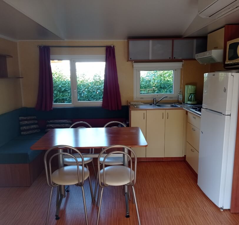 Kitchens in the ‘Le Figuier’ mobile homes available for rent at Le Bel Air campsite in the Lot