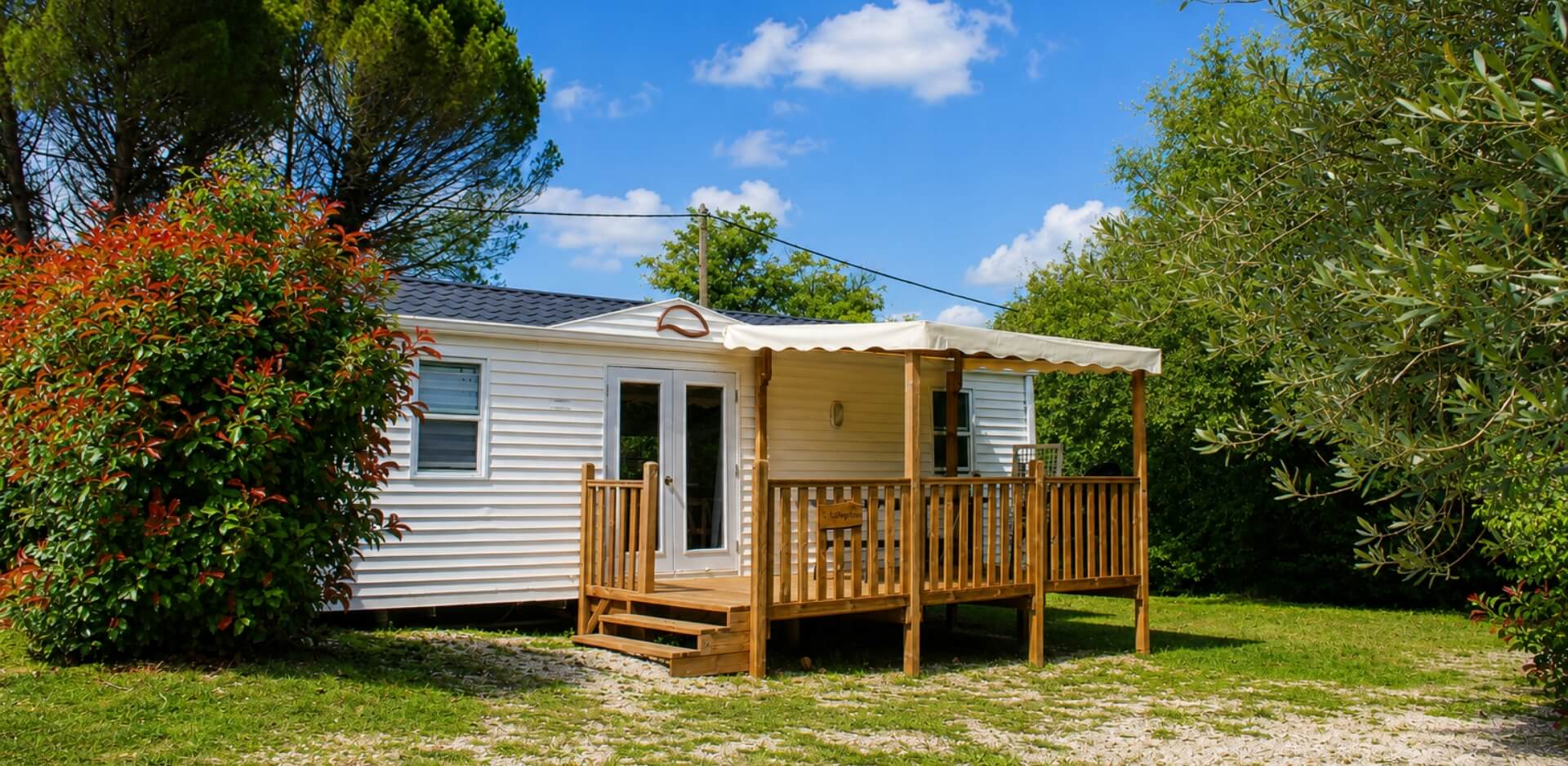 Exterior view of a mobile home for rent at Le Bel Air campsite in the Lot