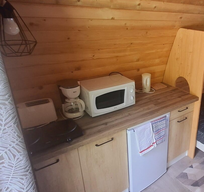 Wooden Pod kitchen, unique accommodation in the Lot with a double bed, available to rent at Le Bel Air campsite in the Lot