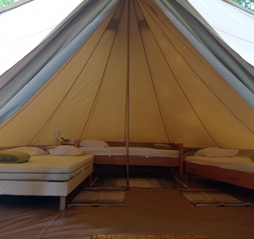 Interior view of the Sibley tent, a unique accommodation option in the Lot, available to rent at Le Bel Air campsite in the Lot