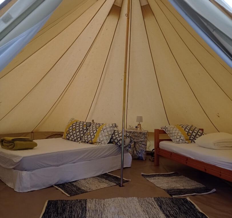 Interior view of the Sibley tent with two beds, unique accommodation in the Lot